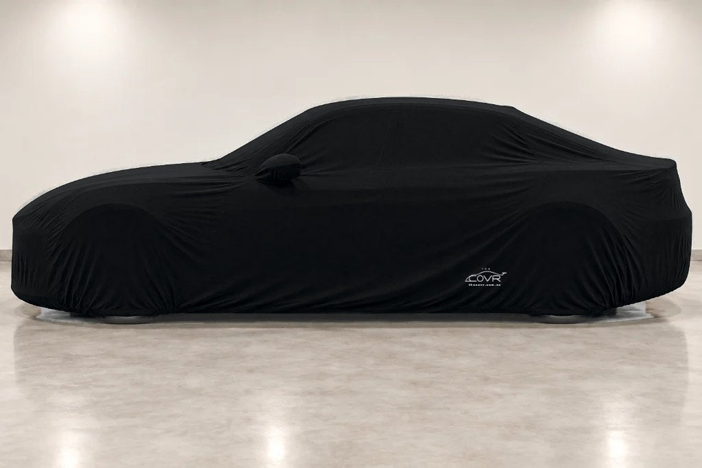 A black Indoor cover on a sedan, seen from the side